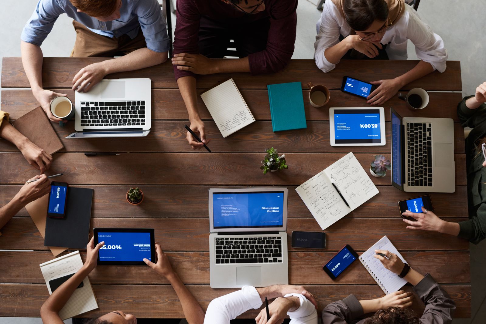 Business team collaborating around a laptop during a startup meeting.