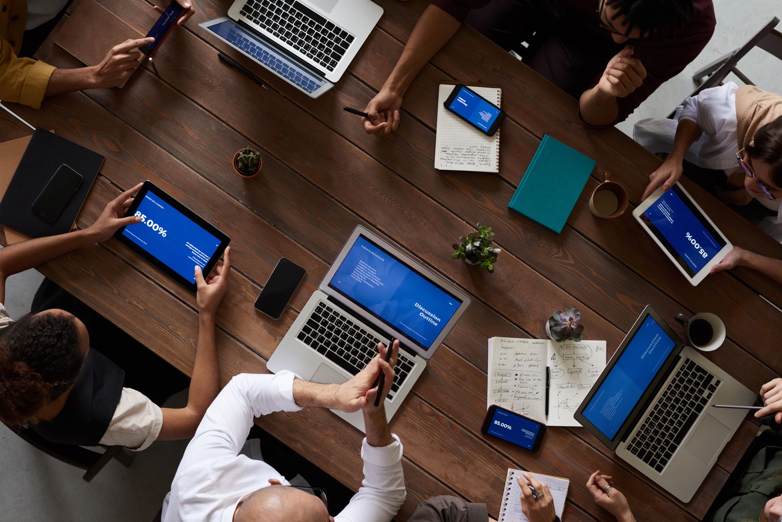 Professional working session in an office with a laptop and people collaborating.